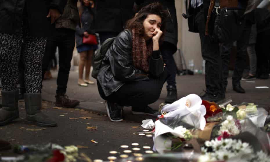  A woman places flowers near the scene of the Bataclan theatre attack.