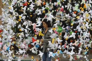 A woman walks past paper birds placed by WWF activists opposite the Spanish Lower House in Madrid, Spain on 24 November, to demand greater protection of Doñana national park in Andalucia