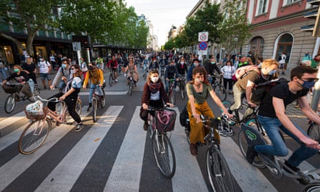 Slovenian citizens wearing protective masks ride their bikes as they block the centre of capital Ljubljana to protest against the centre-right government, accusing it of corruption and of using the pandemic to restrict freedom on 8 May, 2020.