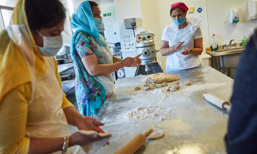 Women roll dough at Guru Nanak Darbar gurdwara in Gravesend, Kent.