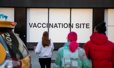 People walk in front of a Covid vaccination site in Brooklyn, New York. 