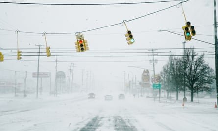 Street lights and snow blow in severe wind gusts in Flint, Michigan.
