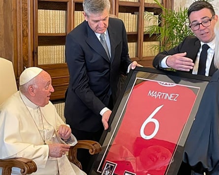 Burnham hands Pope Francis a framed, signed Manchester United shirt.