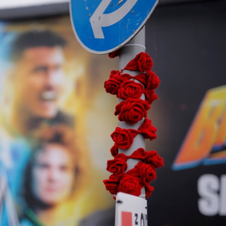 Crocheted red roses wrapped around a road sign outside the stadium before the Women’s Rugby World Cup 2025 semi-final match between England and France.