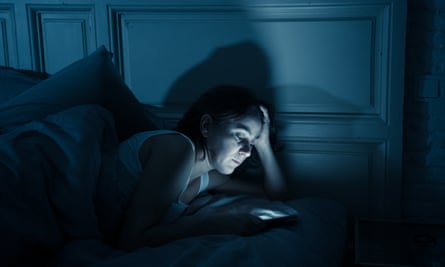 woman with phone in bed