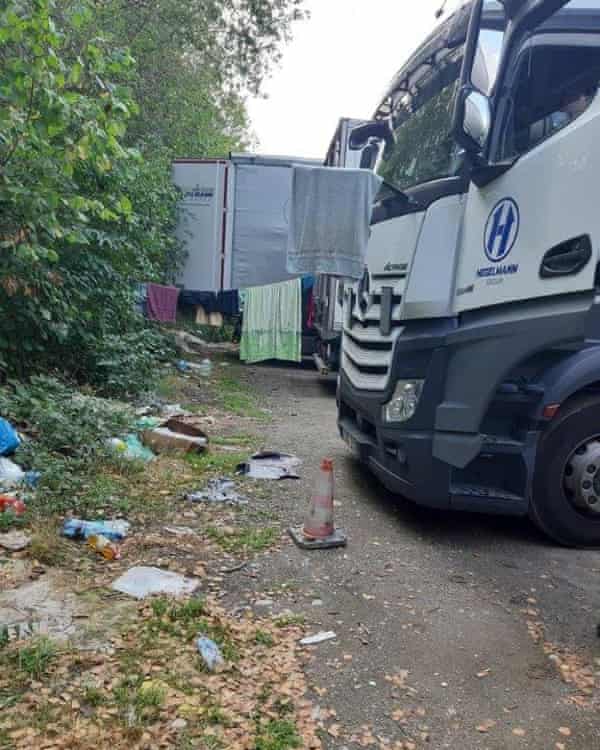 A Hegelmann lorry parked alongside makeshift living arrangements