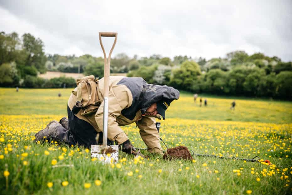 Mick Poole is detecting in a field that contains the remains of a ruined building. Alongside his metal detector he is using his historical knowledge of the area and the visible topography of the land to make an educated guess on which parts of the landscape to explore first