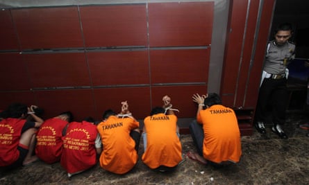 Jakmania supporters are held following trouble in the game against Sriwijaya last June, when a policeman was left in a coma.