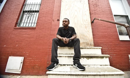 Davon Mayer on the steps of his old home in west Baltimore