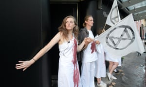 Extinction Rebellion protesters take part in âdie-inâ outside London fashion weekâs headquarters.