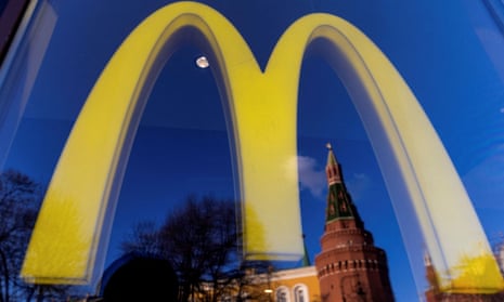 A logo of the McDonald's restaurant is seen in the window in Moscow