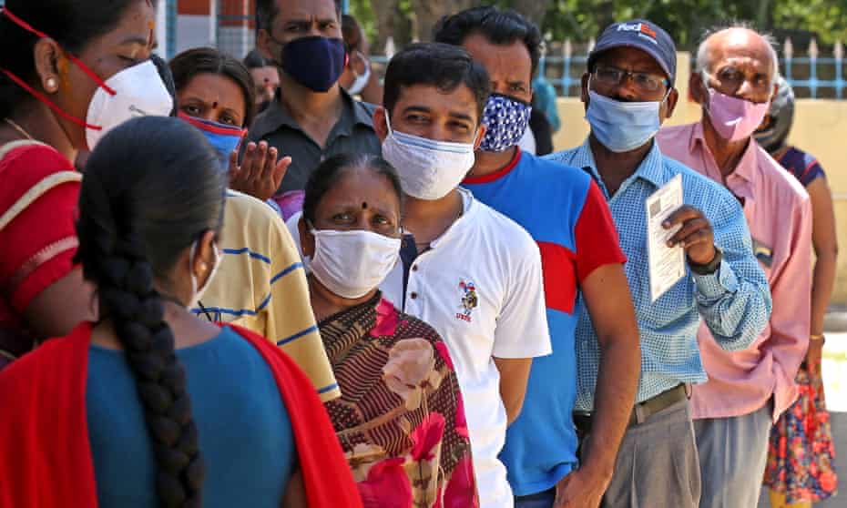 People stand in a queue to be vaccinated in Bangalore, India.