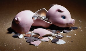 A broken piggy bank, with coins