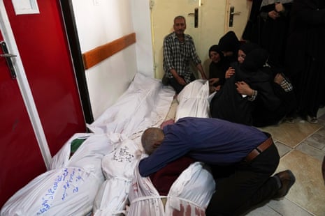 Palestinians mourn their relatives killed in an Israeli airstrikes in Jabalia, northern Gaza Strip, on Wednesday, 14 May.