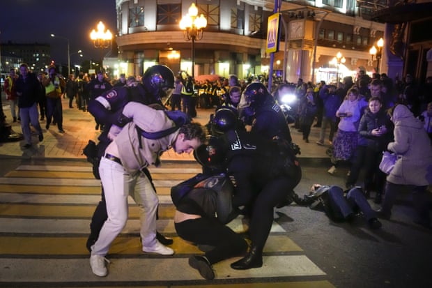 Riot police detain demonstrators in Moscow.