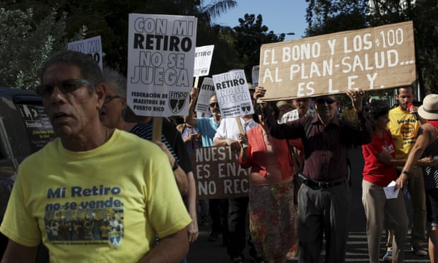 Retired Puerto Rican teachers protest with signs: ‘Don’t play with my retirement.’