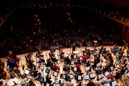 an orchestra playing in front of an audience