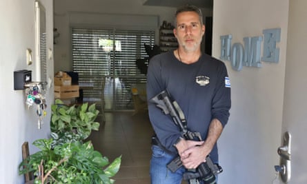 Omer Shita holding a rifle