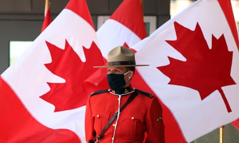 RCMP member in front of canadian flags