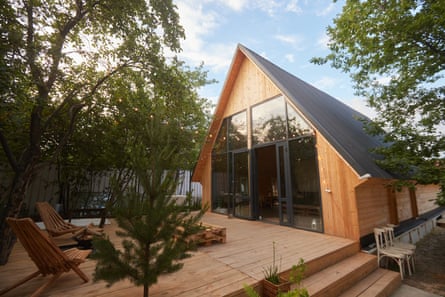 Timber frame house with exterior view through trees.