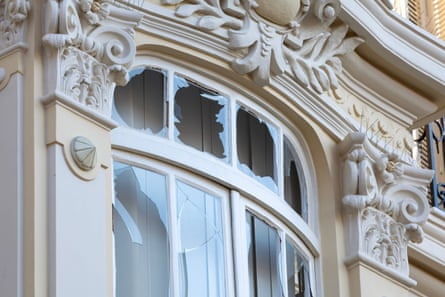 Shattered windows at the front of a white building