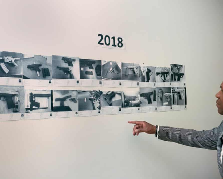 At the Oakland police station, Joyner points at some of the guns that were confiscated in 2018.