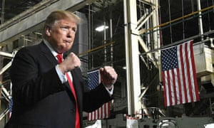 Donald Trump makes two fists while making a public appearance.