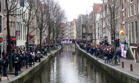 Fans line the canal in Amsterdam.