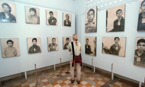 A tourist looks at portraits of Khmer Rouge victims on display at the Tuol Sleng Genocide Museum in Phnom Penh, Cambodia.