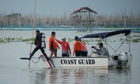 Rescuers search for victims of a capsized ferry in Rizal, Philippines.