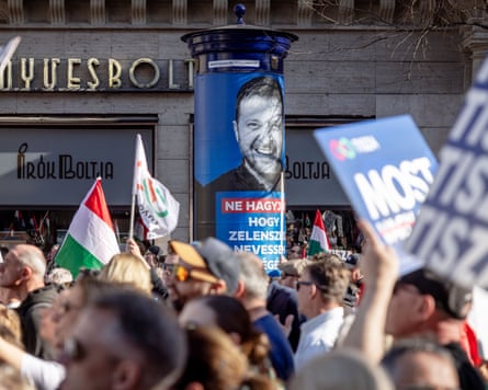 A poster with an image of Volodymyr Zelenskyy is seen over the heads of a crowd of protesters