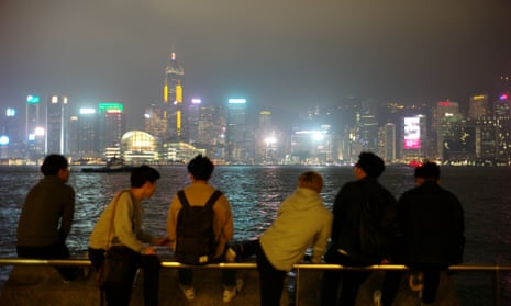 People with smoggy Hong Kong skyline