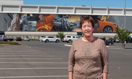 Homelessness worker Tracy Ingram stands in front of a car industry mural on an Elizabeth shopping centre