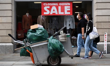 a closing down sale sign and a streetsweeper's cart