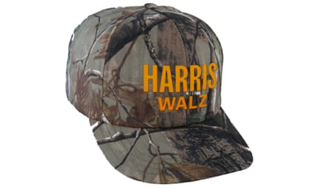A camo baseball cap featuring the embroidered words Harris and Walz in orange