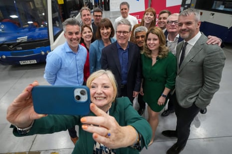 Tracy Brabin, the West Yorkshire mayor, holding her phone and she and other Labour mayors pose for a picture at their meeting today in Wolverhampon.