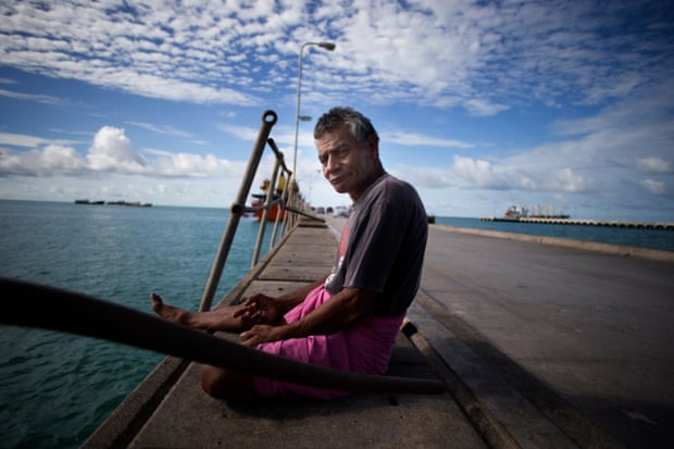 A man fishes off the main wharf at Betio.