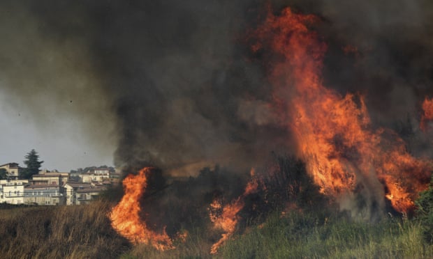 A view of a fire in the Municipality of Blufi, in the upper Madonie, near Palermo, Sicily, Italy, as many wildfires continue plaguing the region. Sicily, Sardinia, Calabria and also central Italy, where temperatures are expected to reach record hights, were badly hit by wildfires. Climate scientists say there is little doubt that climate change from the burning of coal, oil and natural gas is driving extreme events, such as heat waves, droughts, wildfires, floods and storms. (AP Photo/Salvatore Cavalli)