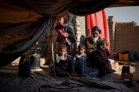 Sediqullah*, 58, with some of his children at the family’s temporary accommodation in Kandahar.