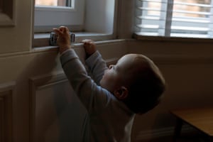 Aven drives a toy car over the windowsill.