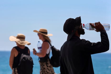 A man drinks from a water bottle