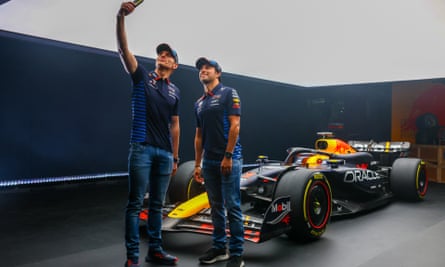 Max Verstappen (left) and Sergio Peréz pose for a selfie with the new Red Bull RB20.