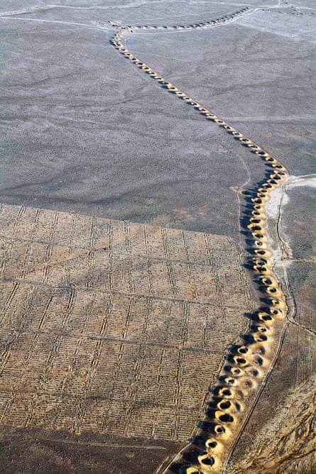 Going underground … a line of evenly spaced spoil craters snakes along the desert towards the Plains of Iraq, evidence of a subterranean man-made water stream called a qanat, first constructed by the Persians.