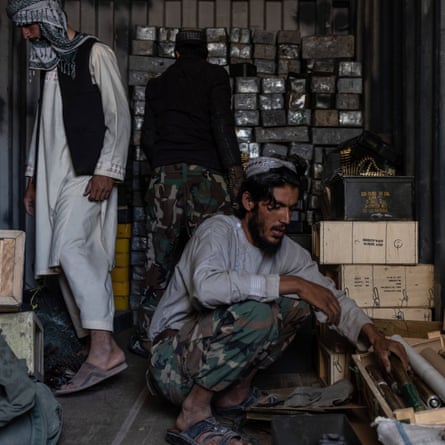 US ammunition in the hands of the Taliban, who are sorting through it at a former US base in Ghazni province, on September 2021.