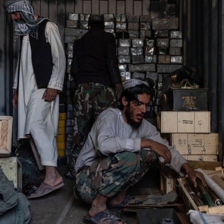 US ammunition in the hands of the Taliban, who are sorting through it at a former US base in Ghazni province, on September 2021.