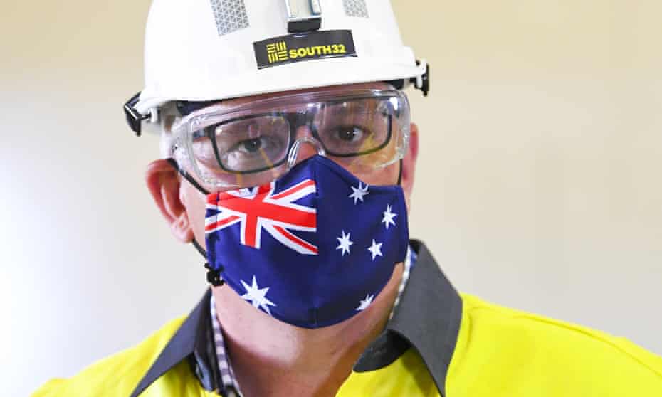 Scott Morrison wears a hard hat and face mask during a visit to a mine