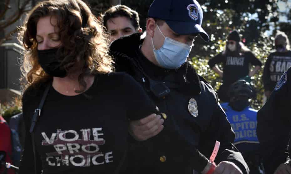 Reproductive rights protesters participate in an act of civil disobedience as oral arguments were heard at the supreme court on 1 December.