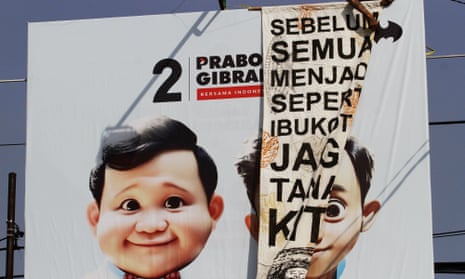 A protest banner over election signage for Prabowo Subianto, Indonesian presidential candidate, and his running mate Gibran Rakabuming Raka.