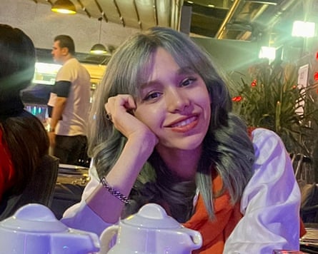Closeup of a smiling young woman seated in a cafe