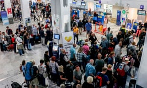 Tourists wait at a Thomas Cook counter at Heraklion airport on the Greek island of Crete. 3519.jpg?width=300&quality=85&auto=forma